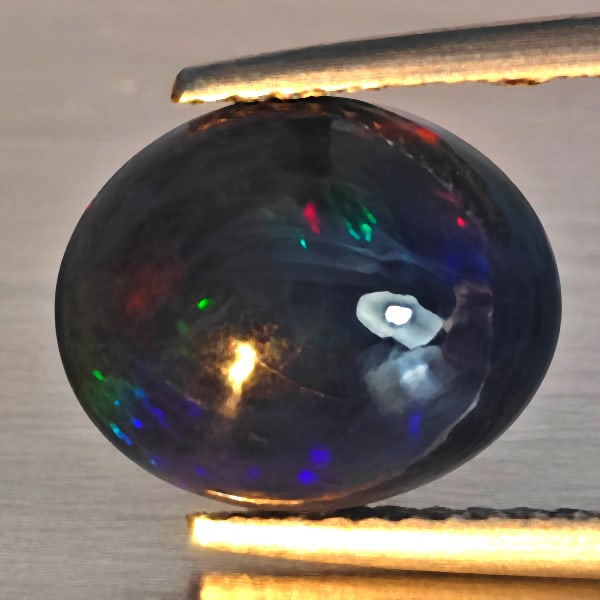 Natural Multi Color Play Of Colour Opal Gemstones 1.56 Ct. Oval Cabochon Shape 10.9 x 9 Mm.: Product ID: 818728601 Product Name: Natural Opal Weight: 1.56 CT. Size: 10.9 x 9 x 4.3 MM. Shape: Oval Cabochon Shape Color: Multi-Color Clarity:Semi - Transparent Luster: Good Gems Origin: Ethiopia T