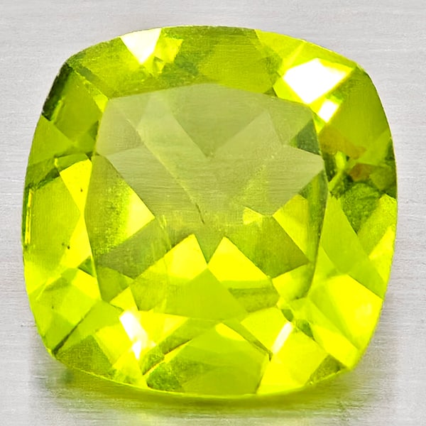 Natural Green Peridot Gemstones 1.38 Ct. Cushion Shape 7.2 Mm.: Product ID: 805317235 Product Name: Natural Peridot Weight: 1.38 CT. Size: 7.2 x 7.2 x 3.7 MM. Shape: Cushion Shape Color: Green Clarity:VSI - SI1 Luster: Good Gems Origin: Pakistan Treatment: Unheate