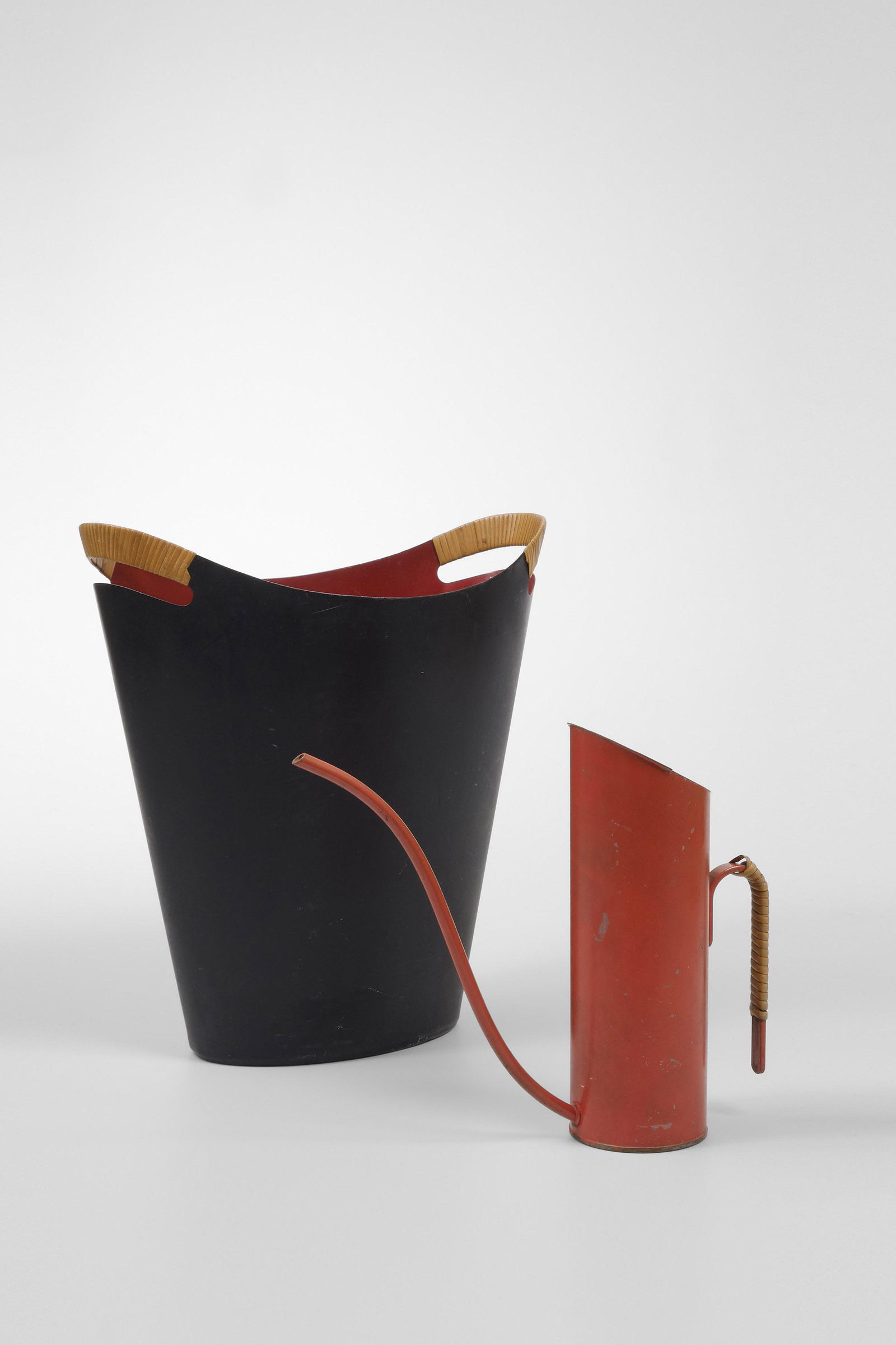 Finn Juhl (Danish, 1912 - 1989) and Gunnar Ander (Swedish, (1908â€“1976): Finn Juhl (Danish, 1912 - 1989) Paper Bin - 1955 Lacquered steel and rattan, 34 cm Finn Juhl & Grethe Kornerup-Bang Gunnar Ander (Swedish, 1908 - 1976) Watering Can - 1950s Lacquered metal and rattan,