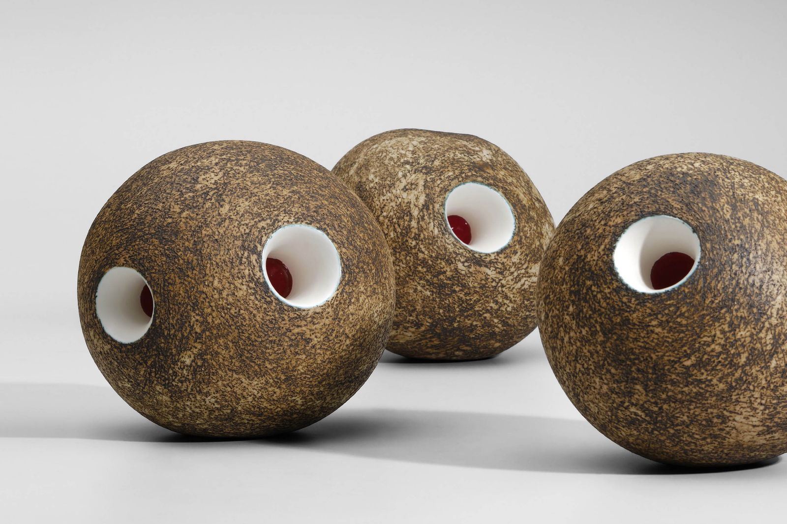 Kristin McKirdy (Canadian, 1958): Three Balls - 2009 Glazed terracotta +/- 18 x 15 x 15 cm (each) Provenance: Pierre Marie Giraud, Brussels