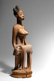 Yoruba Standing Female Figure Offering a Ram: NigeriaWood, 90 cm Provenance: Said to have been one of three sculptures (the others representing horsemen) formerly kept in the shrine of Shango at KosoParke-Bernet Galleries, New York, April 22, 196