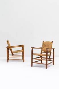 Charlotte Perriand (French, 1903-1993): Pair of N°21 Armchairs - 1935 (design)Called "Chamrousse" Chairs Wood and rattan 78 x 55 x 64 cm Literature: Boris Lacroix, Mobiliers et ensembles de vacances, in Art et Décoration, n&