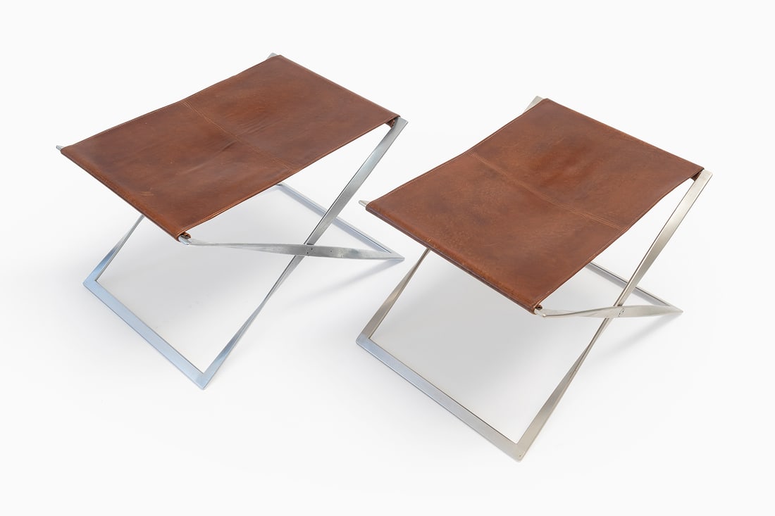 Poul Kjærholm (Danish, 1929-1980): Two PK 91 Folding Stools - 1961 [design] Leather and steel Open: 39 x 60 x 44,5 cm Folded: 70,5 x 46 cm Manufactured by E. Kold Christensen A/S, Copenhagen, Denmark Literature: