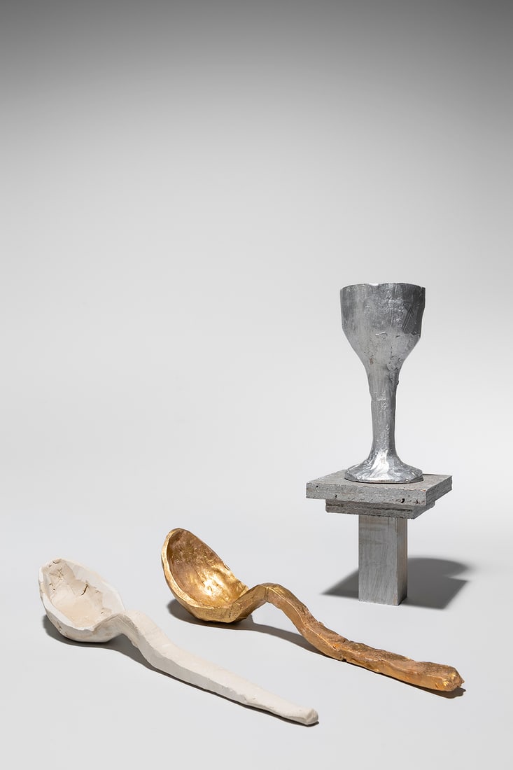 Thomas Houseago (British, 1972): Three Models for Sculptures - c.2000 Plaster and metallic paint Spoon (gold): 4 x 22 cm Spoon (white): 3,5 x 22 cm Glass: 13 x 5,8 cm Provenance: Private collection, Brussels (acquired