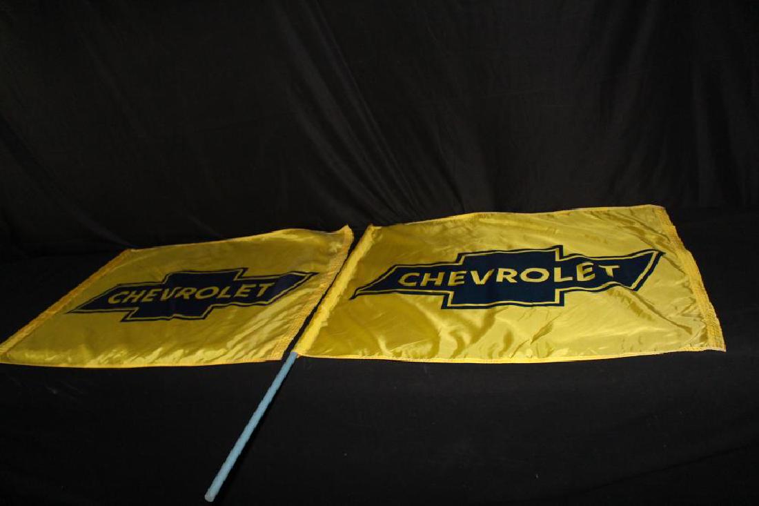 PAIR 1960'S NYLON CHEVROLET DEALERSHIP FLAGS: PAIR 1960'S NYLON CHEVROLET DEALERSHIP FLAGS 39X30". THE FLAGS HAVE THEIR ORIGINAL WOOD POLES. APPROXIMATE SHIPPING COST $22 TO $30. THIS ITEM IS GUARANTEED OLD AND ORIGINAL.