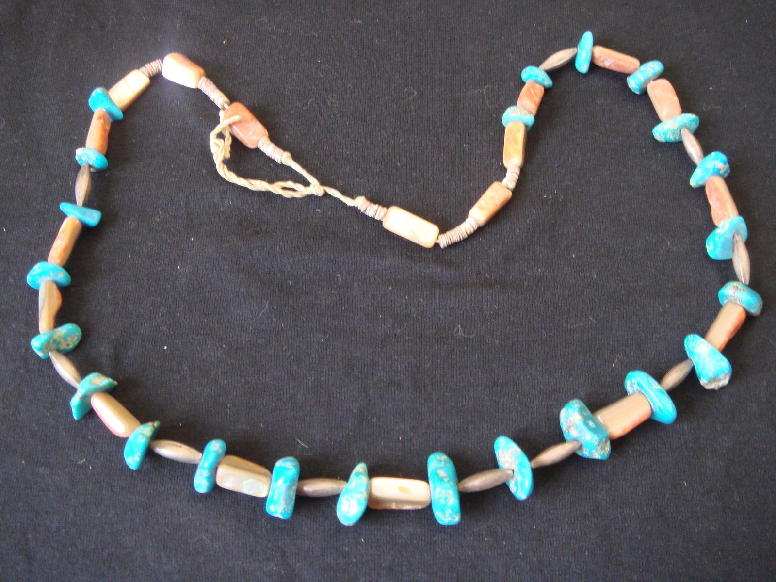 1960's Native American Heishi Turquoise Necklace: 1960's Native American Heishi Turquoise Necklace. Turquoise, Heisi and spiny oyster. Strung on original heavy waxed string. 10 sterling silver elongated bench beads. Beautiful bright Caribbean blue tu