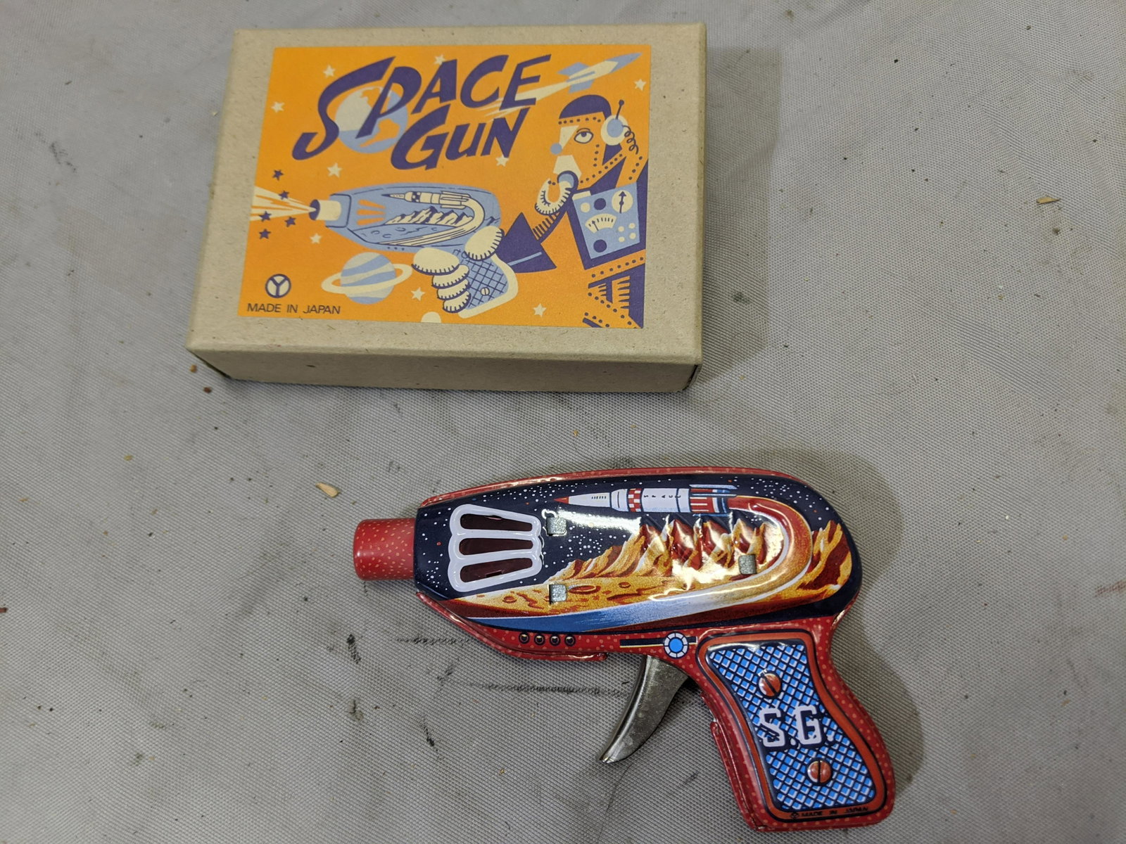 Made in Japan Reissue: Made in Japan Reissue NOS Tin Litho Space Gun in Box 5 long Shipping in continental US $8.00 If shipping is $0 then buyer arranges pick up or shipping. Please ask any questions before bidding Good Luc