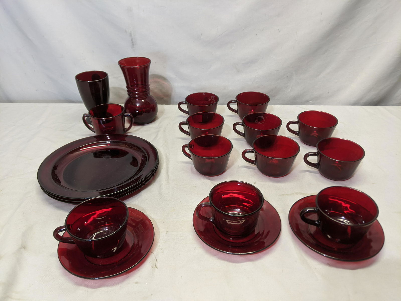 Lot 20 Royal Ruby Red Glassware Cups Saucers Plates etc: Lot 20 Royal Ruby Red Glassware with three plates, three saucers, 11 cups, sugar and two vases Shipping in continental US $40.00 If shipping is $0 then buyer arranges pick up or shipping. Please ask a