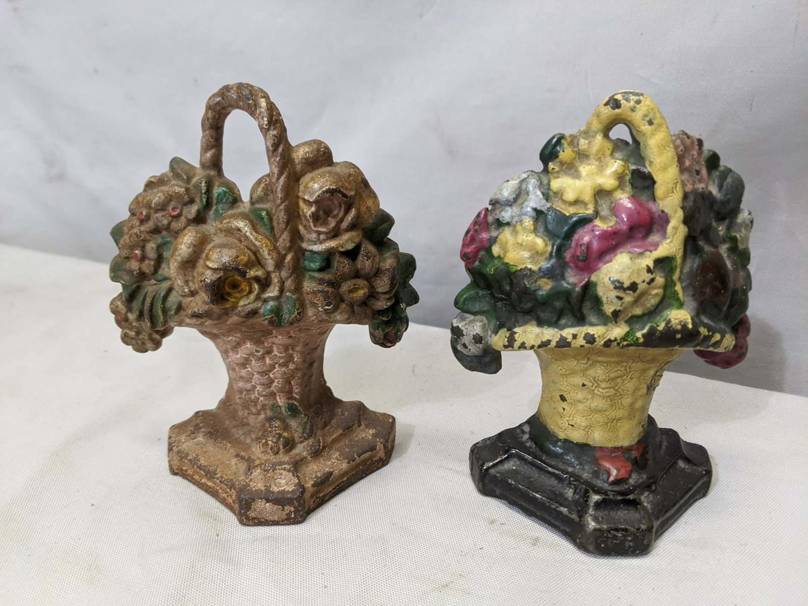 Pair Small Antique Cast Iron Door Stops Flowers in: Pair Small Antique Cast Iron Door Stops Flowers in Basket 6 high Shipping in continental US $15.00 If shipping is $0 then buyer arranges pick up or shipping. Please ask any questions before bidding Go