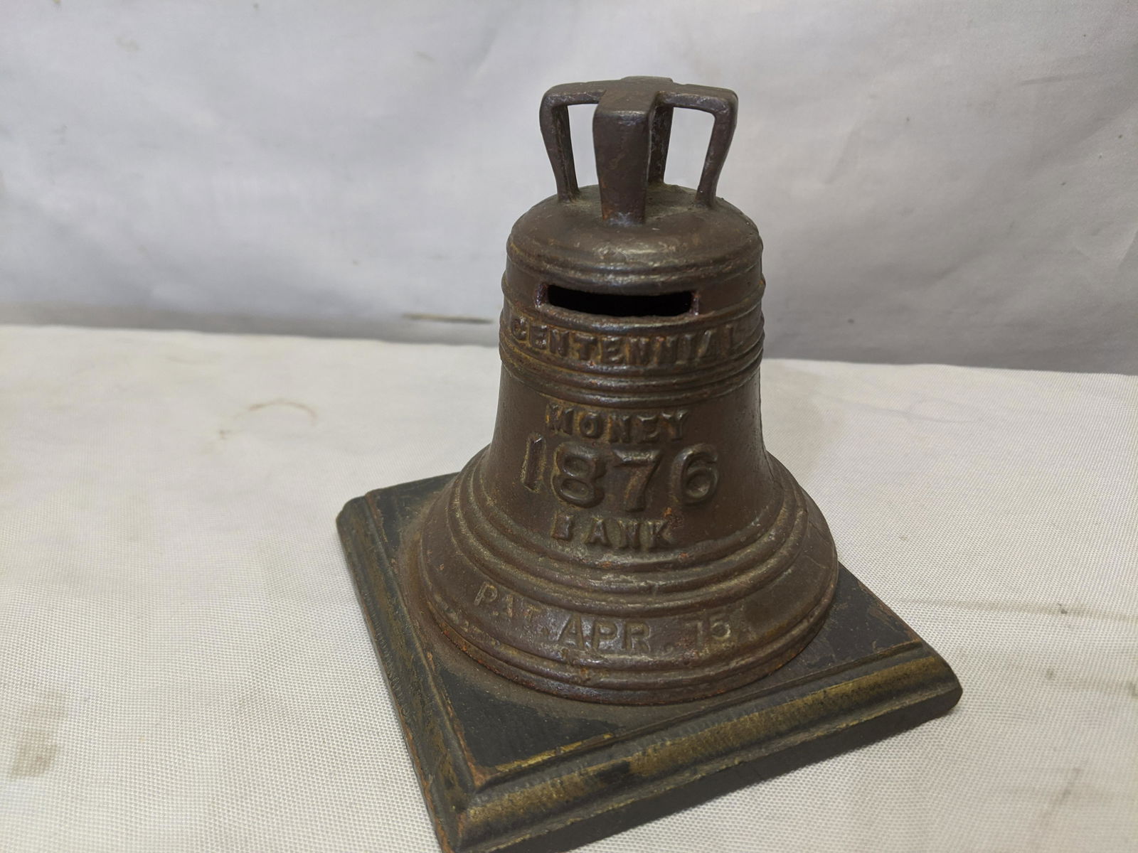 1876 Centennial Bailey's Bells Money Still Bank: 1876 Centennial Bailey's Bells Money Metal Still Bank on wood base 5 high x 4 1/2 square Shipping in continental US $15.00 If shipping is $0 then buyer arranges pick up or shipping. Please ask any que