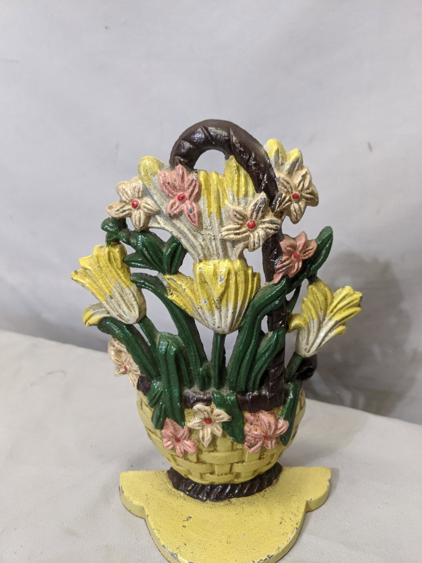 Antique Cast Ion Flowers in Basket Door Stop: Antique Cast Ion Flowers in Basket Door Stop 9 1/2 high Shipping in continental US $15.00 If shipping is $0 then buyer arranges pick up or shipping. Please ask any questions before bidding Good Luck!