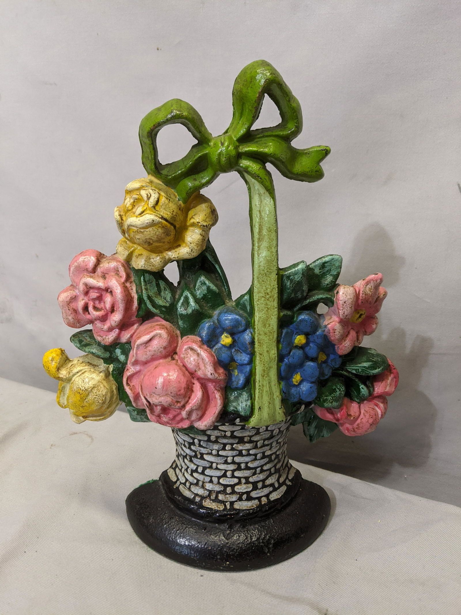 Antique Flowers in Basket w/ Ribbon Cast Iron Door Stop: Antique Flowers in Basket w/ Ribbon Cast Iron Door Stop 10 1/2 high Shipping in continental US $18.00 If shipping is $0 then buyer arranges pick up or shipping. Please ask any questions before bidding