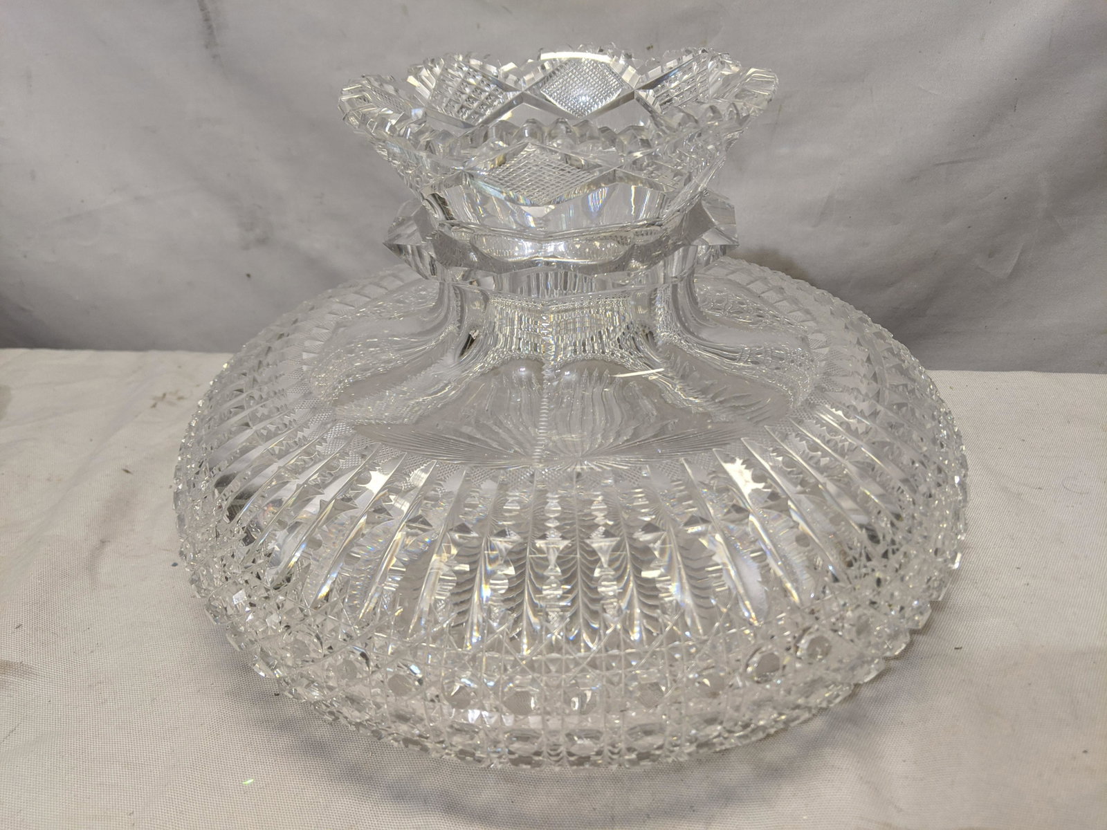 Antique Cut Glass Wide Ornate Vase: Antique Cut Glass Wide Ornate Vase. Measurements in inches:7 1/2 high x 12 diameter We offer in-house shipping. Item(s) will be packed after invoice is paid and shipping cost will be collected seperat