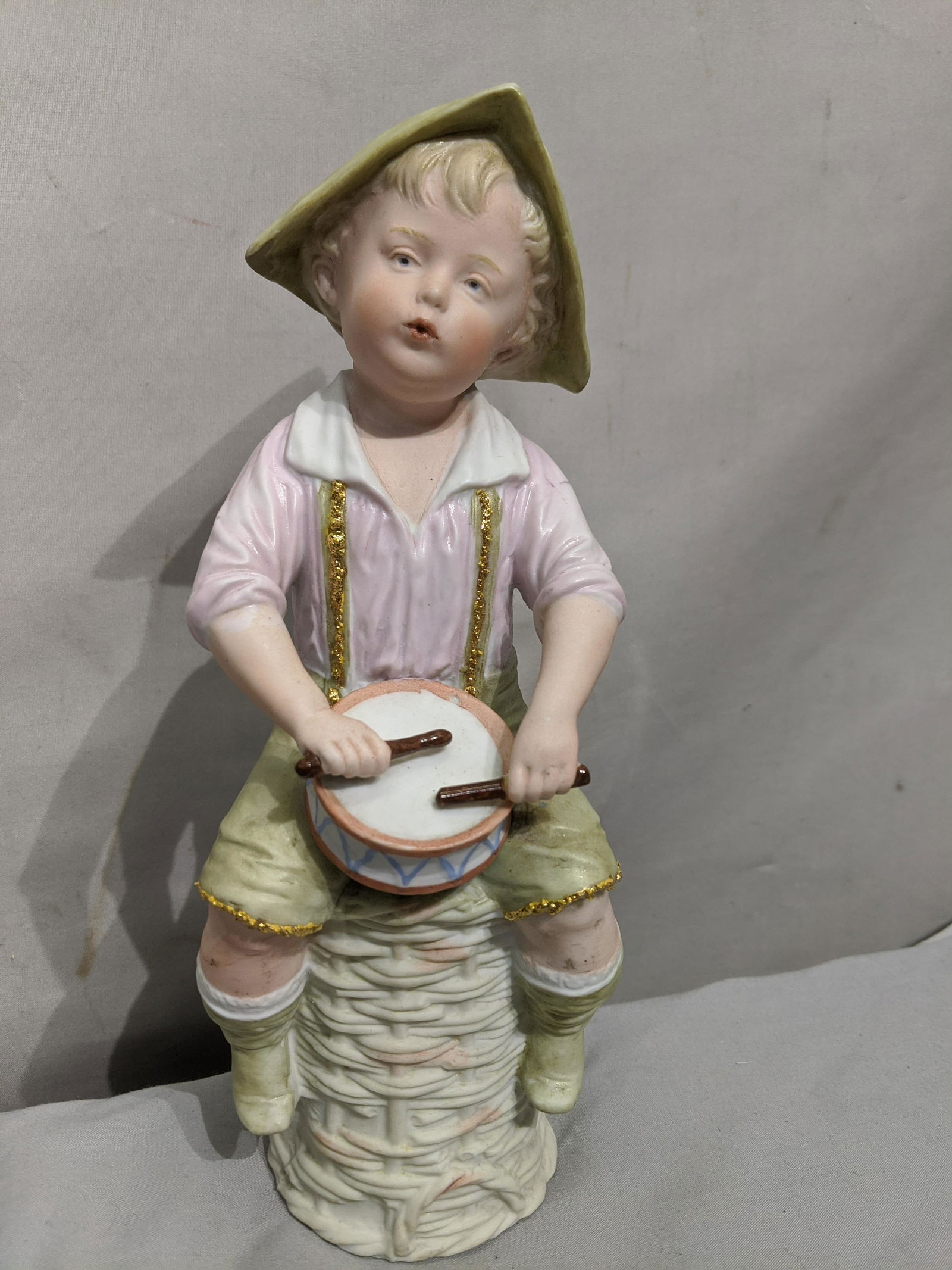 Antique Bisque Heubeck Young Boy w/ Drum Figure: Antique Bisque Heubeck Young Boy w/ Drum Figure. Measurements in inches: 9 1/4 high We offer in-house shipping. Item(s) will be packed after invoice is paid and shipping cost will be collected seperat