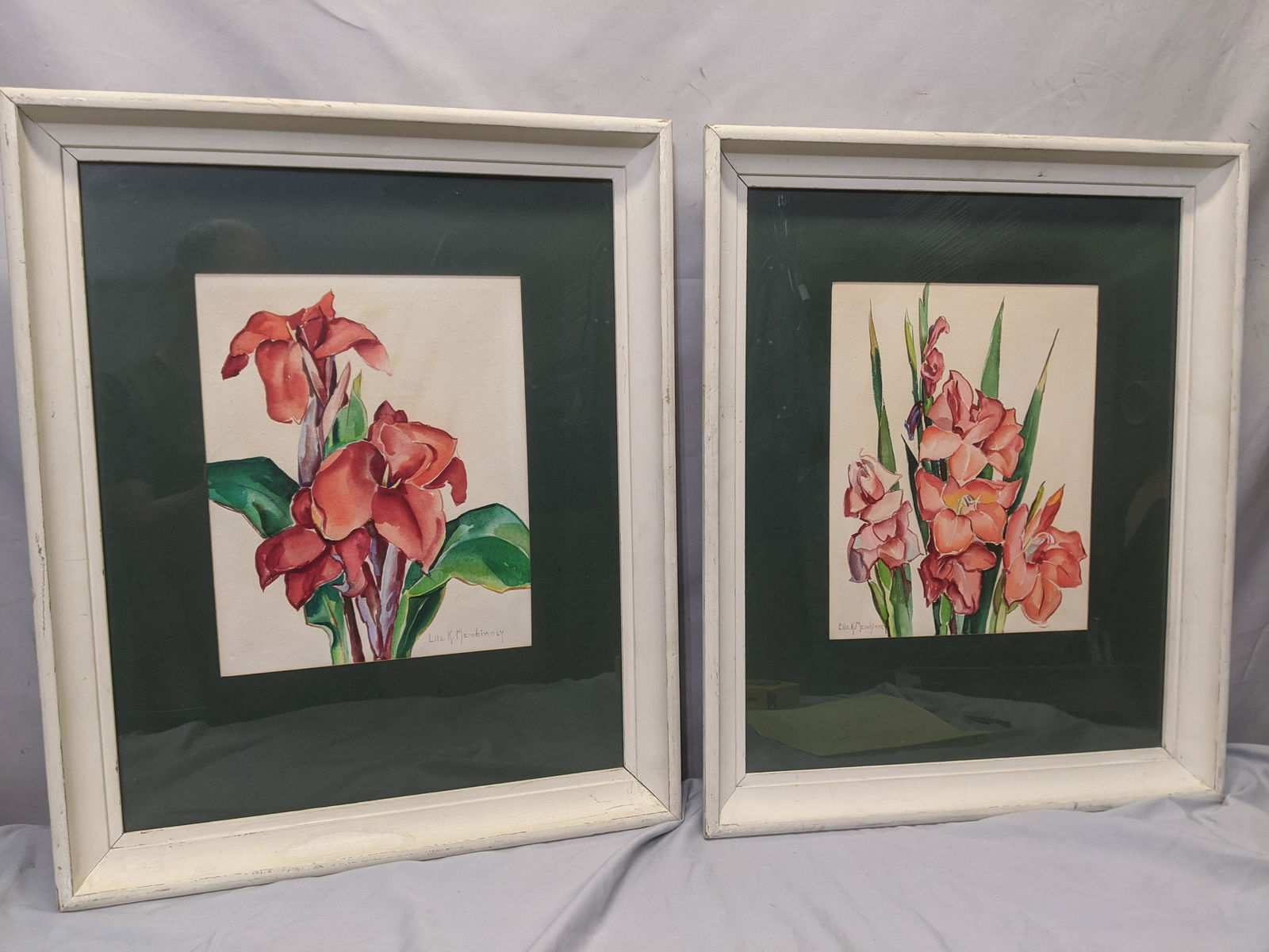 Pair Ella Mewhinney Floral Watercolor Paintings Framed: Pair Ella Mewhinney Floral Watercolor Paintings Framed under glass. Listed Texas artist (1891 - 1975). Measurements in inches: 23 x 19, Image: 9 1/2 x 12 Condition:Some light toning. Frame shows wear