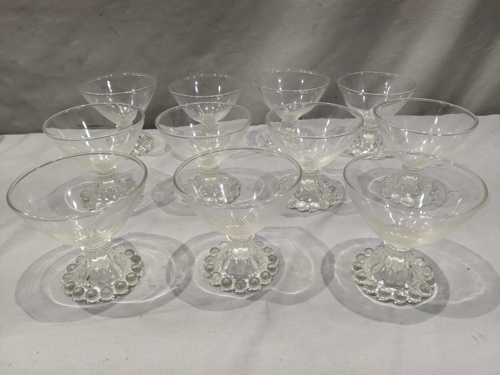 Set 11 Imperial Candlewick Clear Glass Wine Glasses: Set 11 Imperial Candlewick Clear Glass Wine Glasses. Measurements in inches: 3 1/2 high x 3 3/4 diameter Condition:Good with no chips, cracks or repairs Shipping:We offer in-house shipping. Item(s) wi