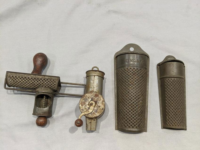 Lot 4 Antique Metal Spice Graters & Grinder: Lot 4 Antique Metal Spice Graters & Grinder including Kreamer grater 6 1/2 x 2 1/2, smaller grater 5 x 2, slide grater 5 x 5 and crank handle grater 4 x 1 1/2. Condition:Normal wear with age and use a