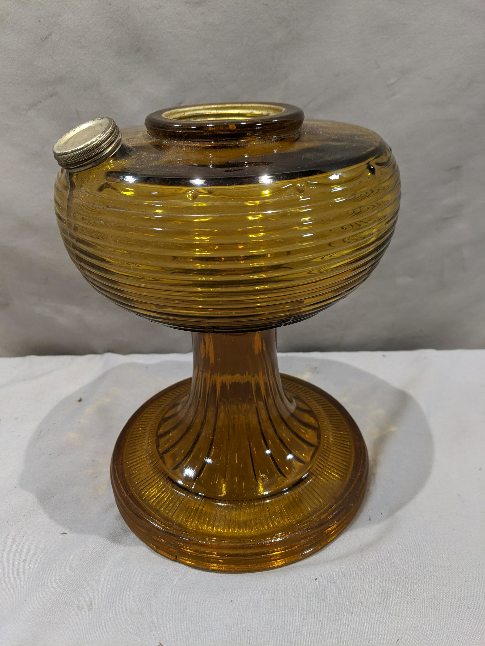 Antique Amber Glass Footed Oil Lamp Font Base: Antique Amber Glass Footed Oil Lamp Font Base. Measurements in inches: 9 high x 7 diameter Condition:No chips or cracks, needs a good cleaning Shipping:We offer in-house shipping. Item(s) will be pack