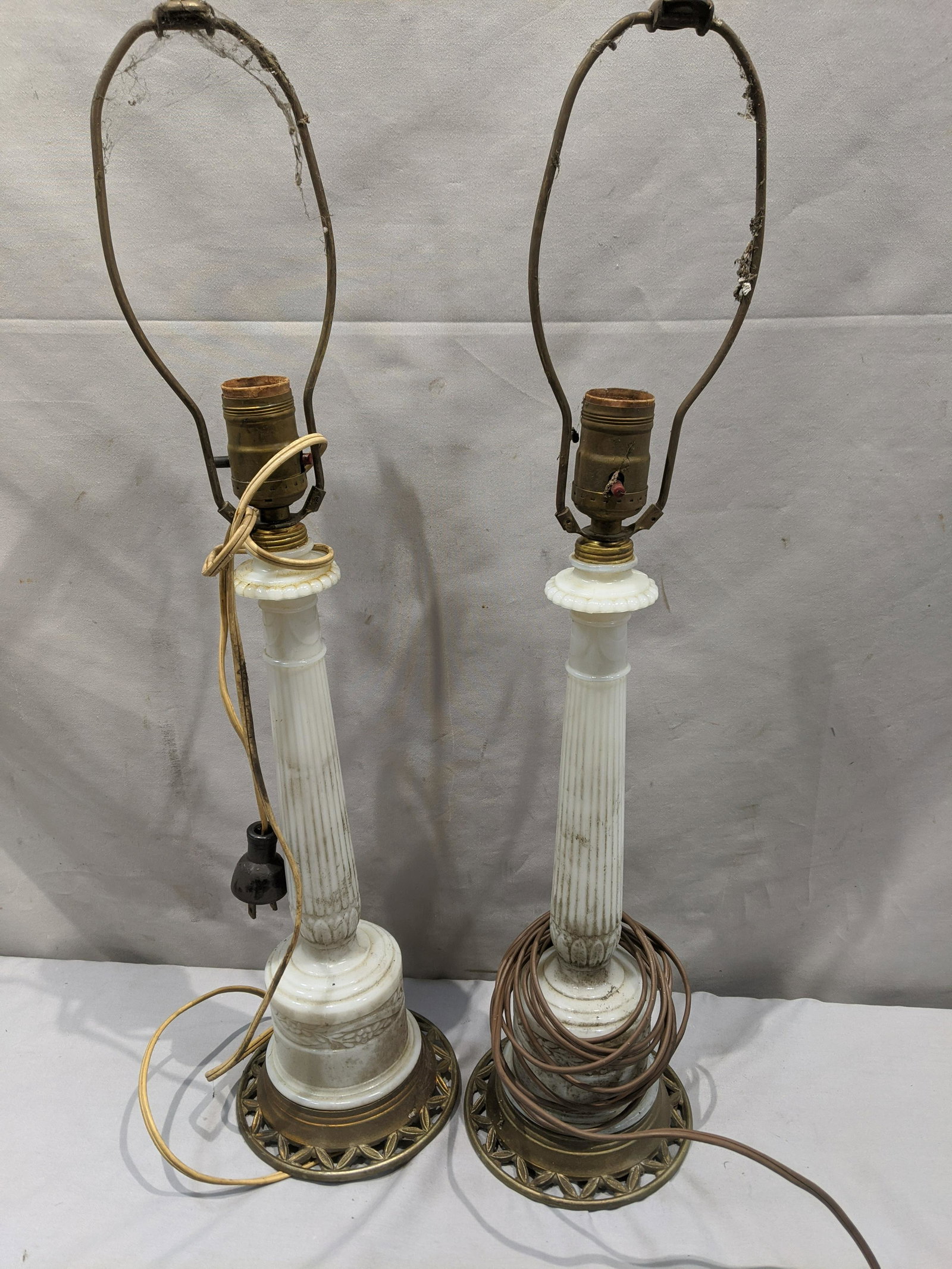 Pair Antique Alacite White Glass Column Table Lamps: Pair Antique Alacite White Glass Column Table Lamps. Measurements in inches: 24 high Condition:One works, other does not. Needs good cleaning, one loose from base Shipping:We offer in-house shipping. 