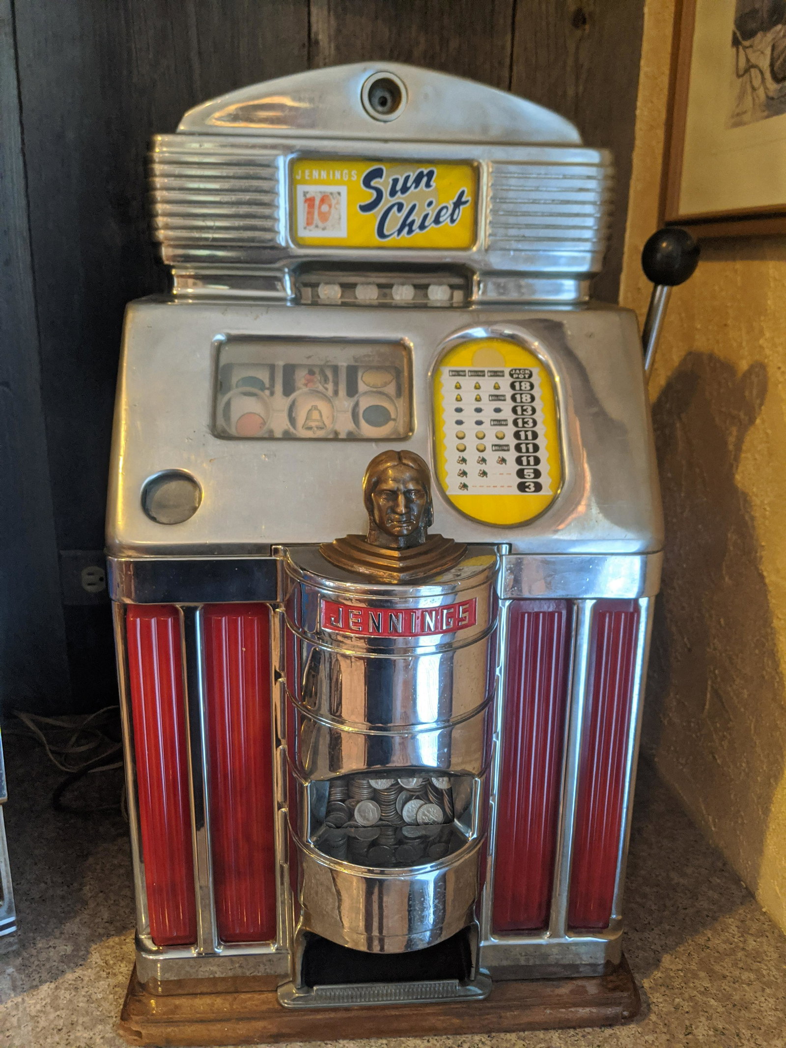 Antique Jenning's Sun Chief 10 Cent Slot Machine: Antique Jenning's Sun Chief 10 Cent Slot Machine. Measurements in inches: 28 high x 15 x 15 Condition:Chrome is peeling in spots, Mechanism does not work, contacts probably needs cleaning Shipping:Buy