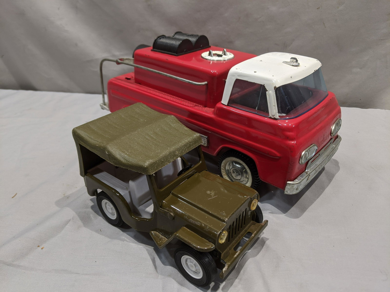 1960's Tonka Army Jeep & Nylint 8100 Suburban Pumper: 1960's Tonka Army Jeep & Nylint 8100 Suburban Pumper. Measurements in inches: 12 long and 6 1/2 long Condition:As found, pumper missing some parts Shipping:We offer in-house shipping. Item(s) will be 