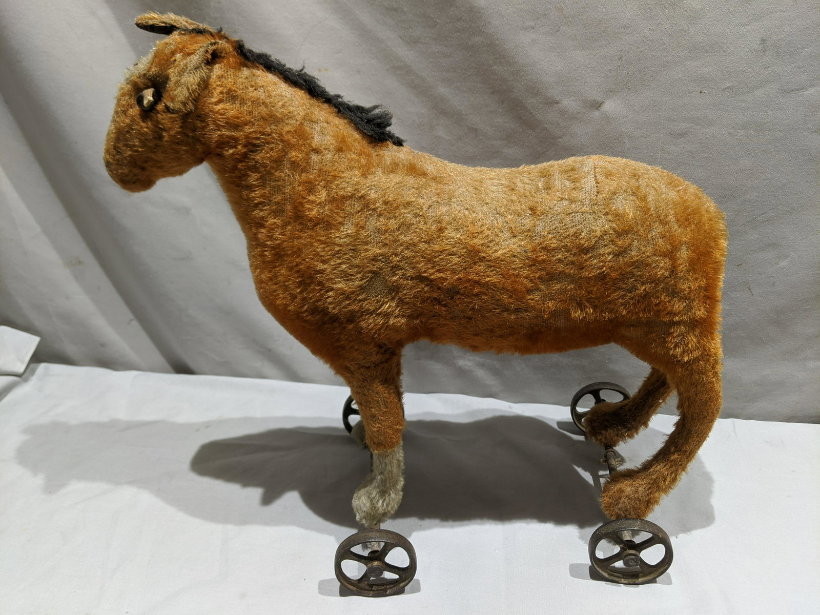 Antique Large Stuffed Horse Rolling Pull Toy: Antique Large Stuffed Horse Rolling Pull Toy. Measurements in inches: 14 high x 15 long Condition:Coat is well worn, no tail Shipping:We offer in-house shipping. Item(s) will be packed after invoice i