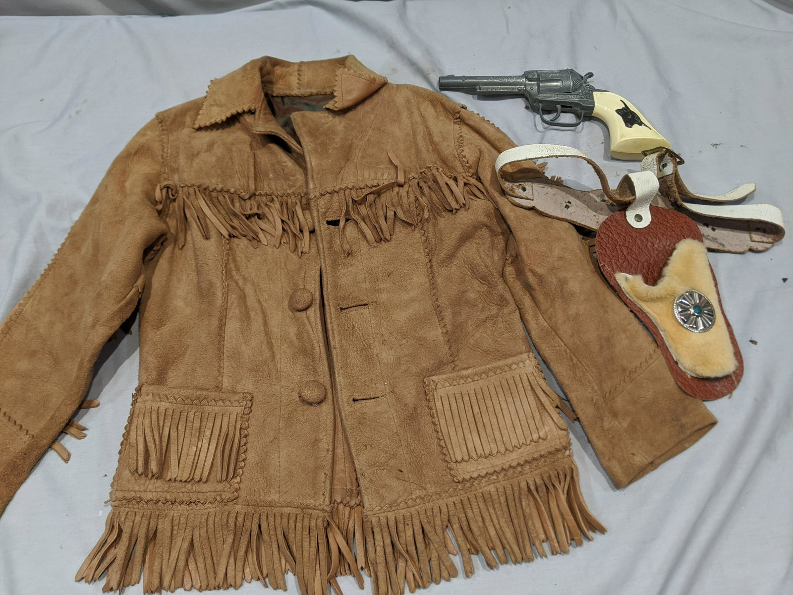 1950s Childs Gabriel Cap Gun Holster & Suede Cowboy: 1950s Childs Gabriel Cap Gun Holster & Suede Cowboy Jacket (20 long, 13 across chest, 12 across shoulders and 14 arm). Condition:All shows wear with age and use Shipping:We offer in-house shipping. It