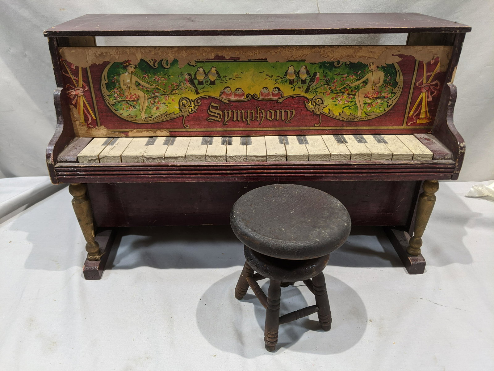 Antique Schoenhut Symphony Doll Piano w/ Stool: Antique Schoenhut Symphony Doll Piano w/ Stool. Measurements in inches: 12 high x 9 x 23 Condition:Well worn with age and use Shipping:We offer in-house shipping. Item(s) will be packed after invoice 