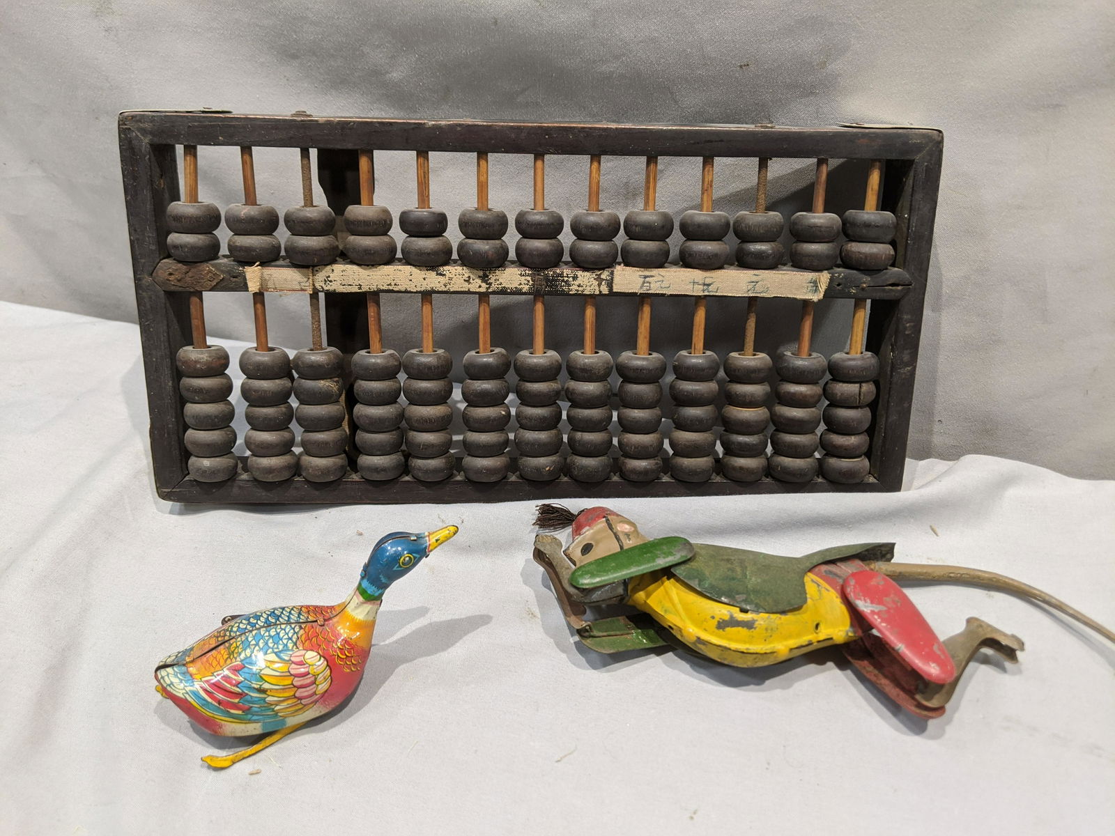 Lot 3 Old Toys Tin Litho Monkey Duck & Wood Abacus: Lot 3 Old Toys Tin Litho Monkey Duck & Wood Abacus. Measurements in inches: 12 x 6 abacus Condition:As found, sold as is Shipping:We offer in-house shipping. Item(s) will be packed after invoice is pa