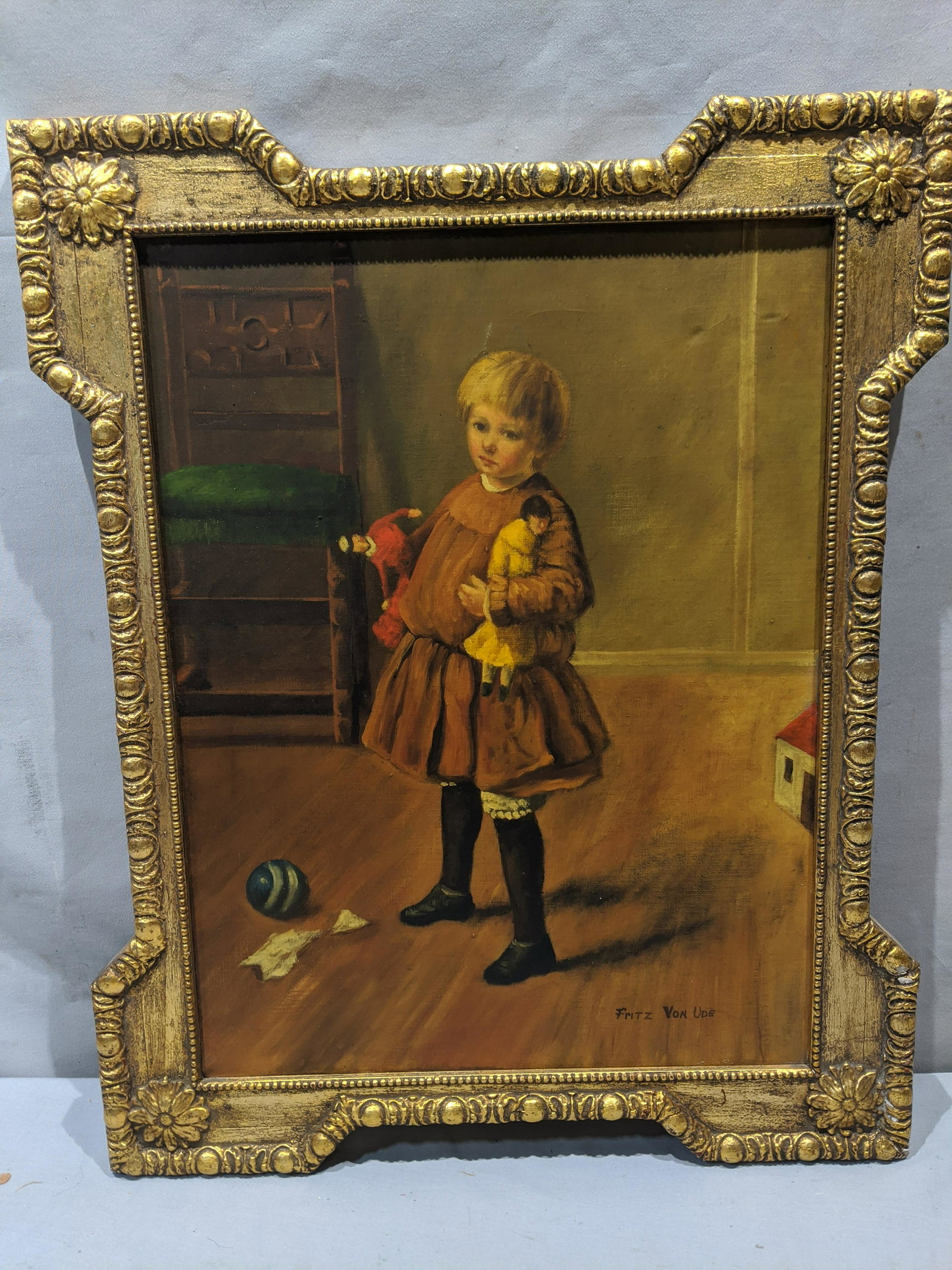 Fritz Von Ude German Child w/ Toys Oil Painting: Fritz Von Ude German Child w/ Toys Oil Painting on canvas in frame. Signed lower right.. Measurements in inches: 16 x 19 1/2, Image: 12 x 16 Condition:Has craquelure Shipping:We offer in-house shippin