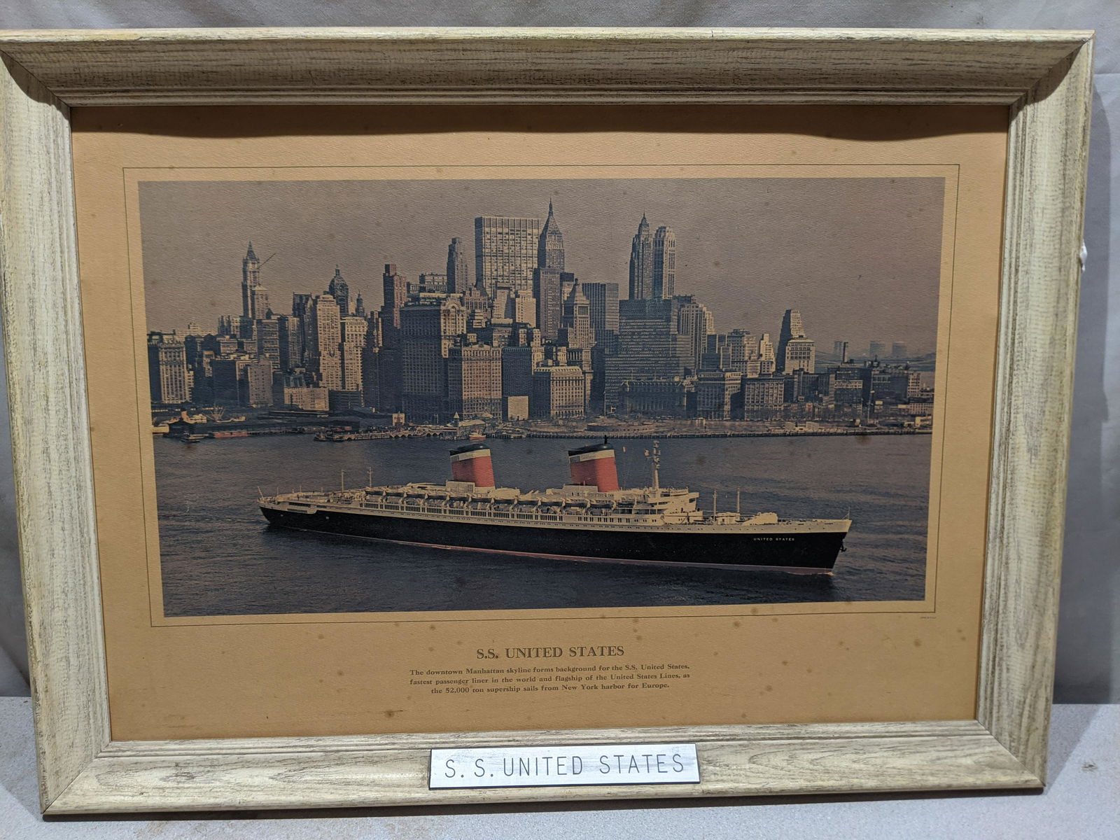 SS United States by Manhattan Steamship Print: SS United States by Manhattan Steamship Print in frame. Measurements in inches: 26 1/2 x 19 1/2, Image: 20 x 11 Condition:Has spotting and browning Shipping:We offer in-house shipping. Item(s) will be