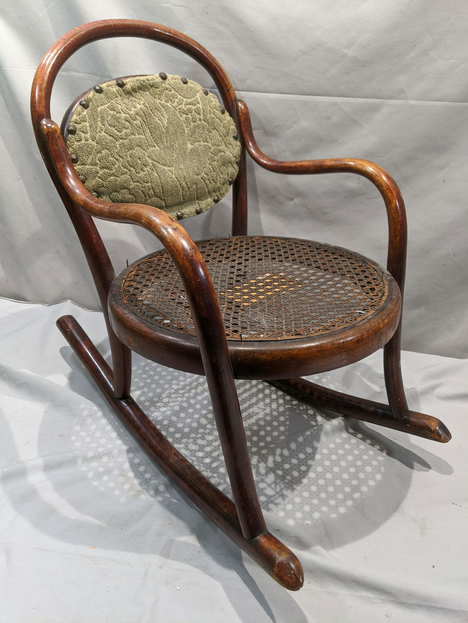 1950s Fischel Mahogany Cushion & Caned Childs Doll Rock: 1950s Fischel Mahogany Cushion & Caned Childs Doll Rocking Chair. Measurements in inches: 20 x 23 x 10 Condition:Has wear with age, damage to canning on back of cushion Shipping:We offer in-house ship