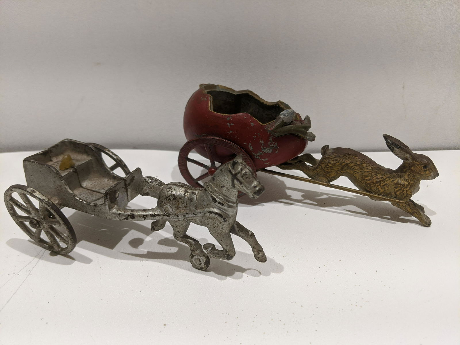 2 Antique Metal Toys Horse & Rabbit Pulling Carriage: 2 Antique Metal Toys Horse & Rabbit Pulling Carriage. Measurements in inches: 5 1/2 and 6 1/2 long Condition:Normal wear with age and use, no riders Shipping:We offer in-house shipping. Item(s) will b