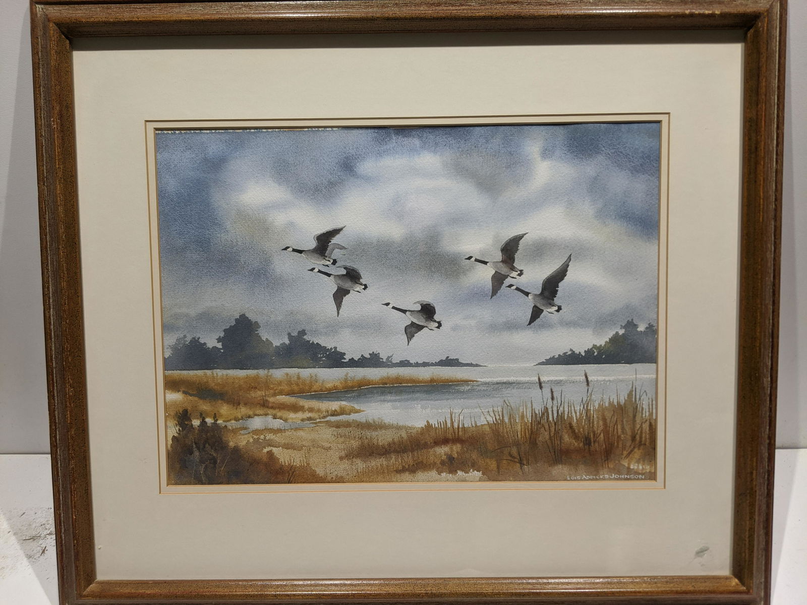Lois Addicks Johnson Geese Over Pond Watercolor: Lois Addicks Johnson Geese Over Pond Watercolor painting framed under glass. Signed lower right. Measurements in inches: 26 1/2 x 23 1/2. image: 18 x 12 3/4 Condition:Good with no problems Shipping:We