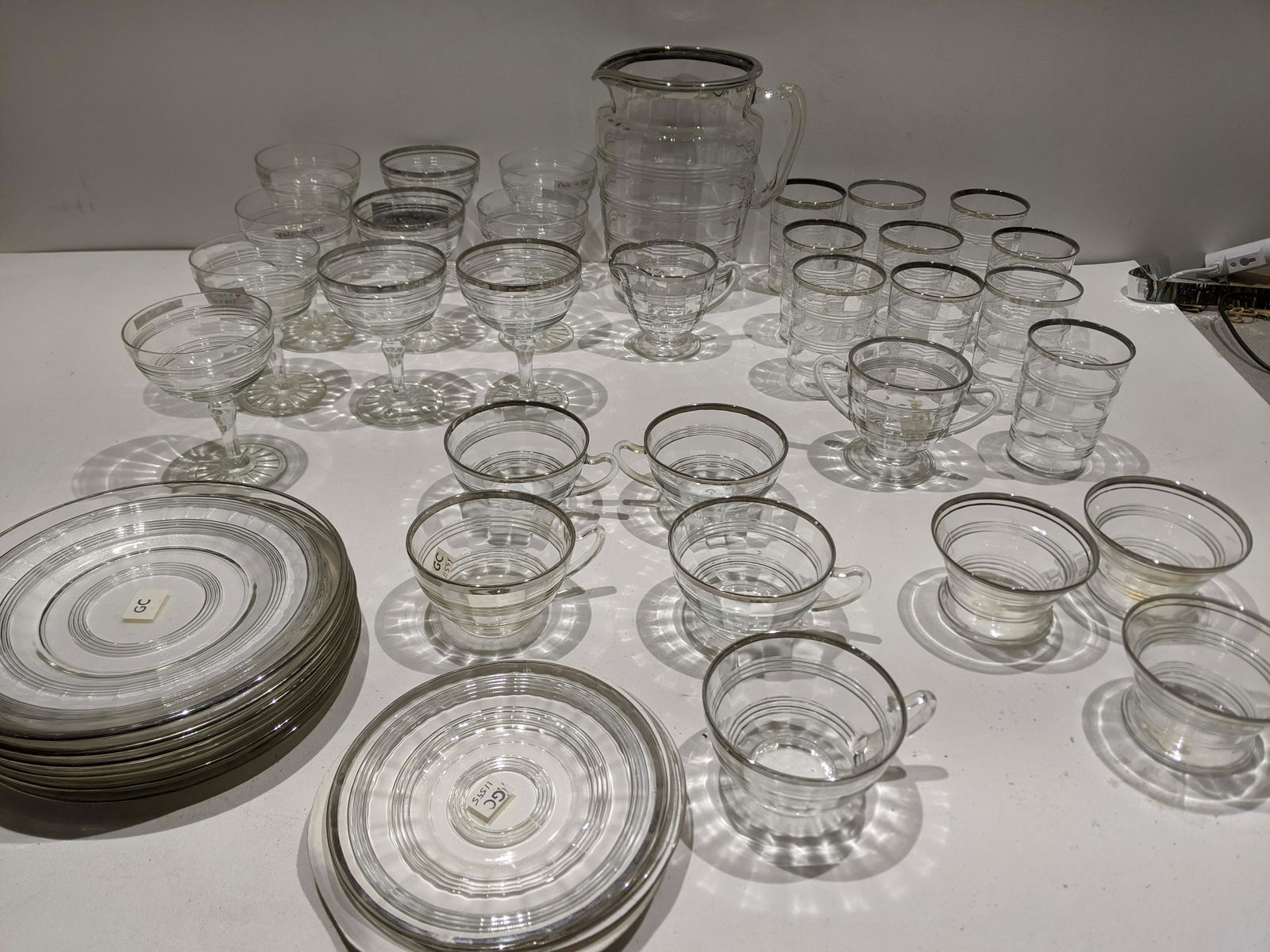 Lot 39 Art Deco Ring Crystal Glass Pieces: Lot 39 Art Deco Ring Crystal Glass Pieces including cups, tumblers, sherbets, coffee cups, berry bowl, plates, pitcher, creamer and sugar. Condition:As found, Sold as is. No obvious cracks or chips Sh