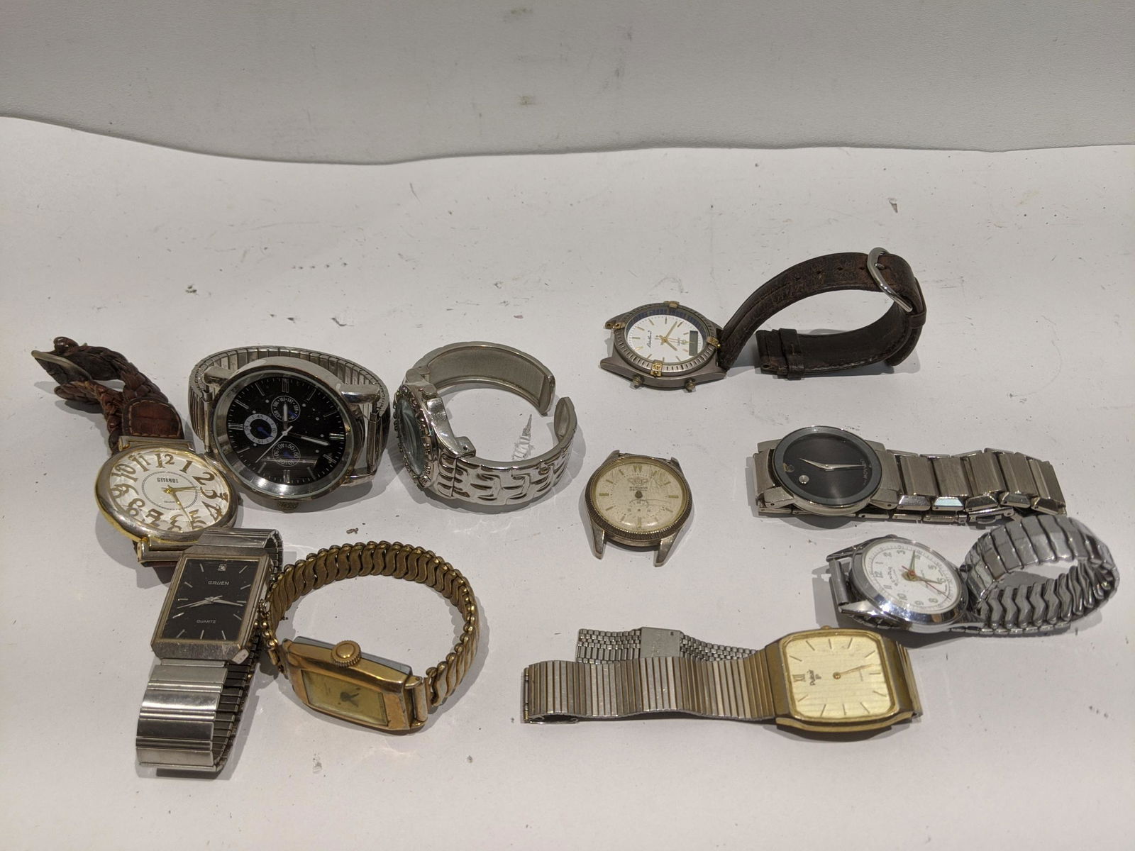 Lot 10 Vintage Men's Wristwatches Movado Gruen etc: Lot 10 Vintage Men's Wristwatches Movado, Gruen, Genova, Windsor, New Haven, Gitano, Eddie Bauer and Pulsar. Condition:As found, sold as is Shipping:We offer in-house shipping. Item(s) will be packed