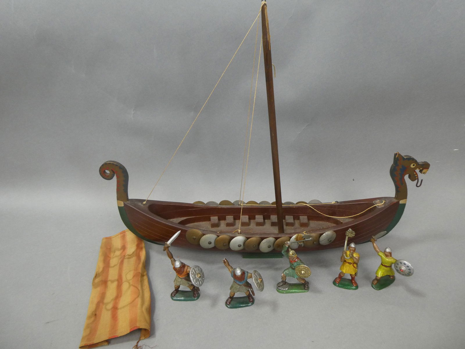 Gaarde Denmark Viking Wood Ship & 5 Krolyn Figures: Gaarde Denmark Viking Wood Ship & 5 Krolyn Figures. Measurements in inches: 20 long ship, 4 high figures Condition:One figure has broken arm, ship and sail have soiling and wear Shipping:We offer in-h