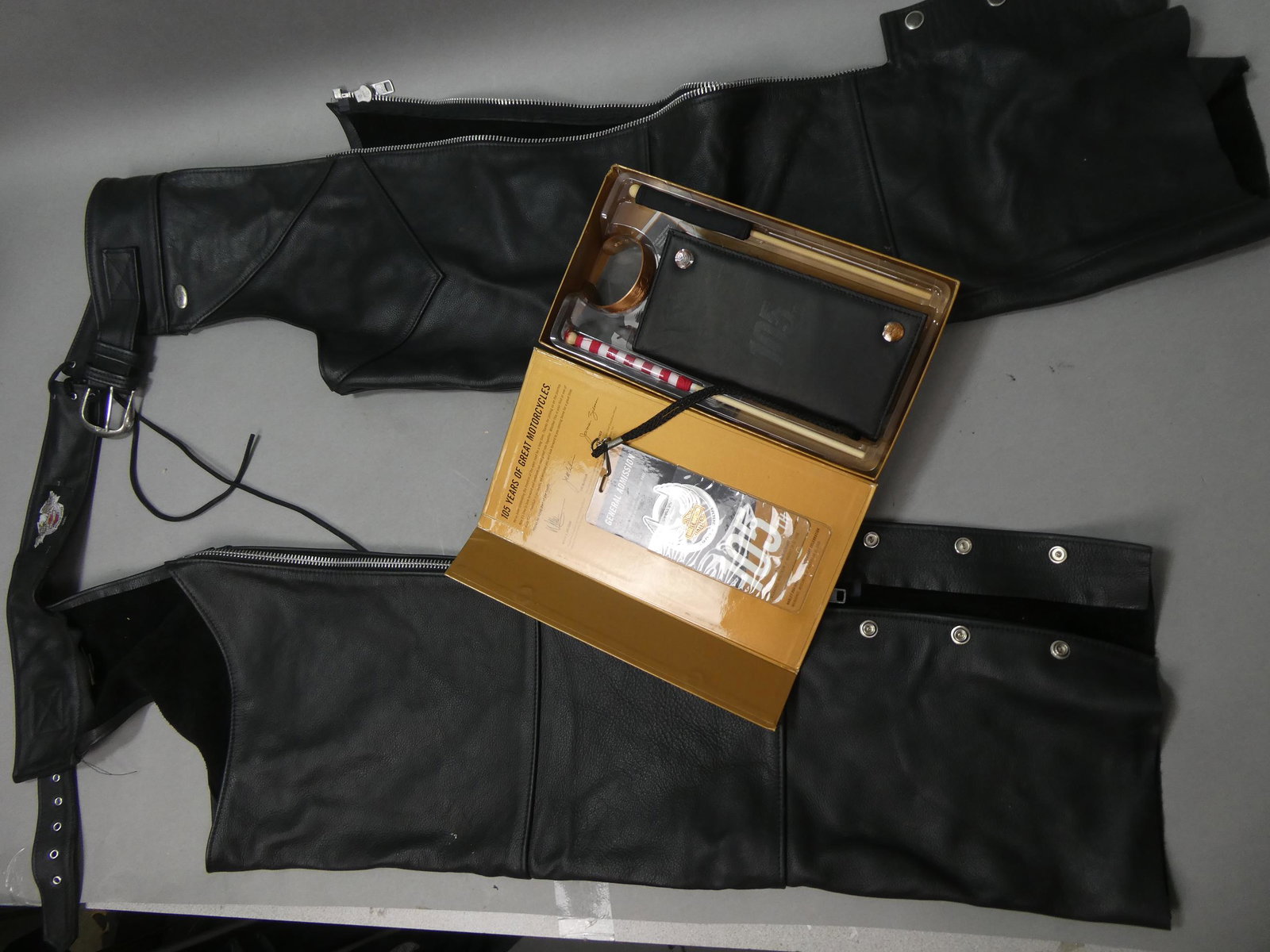 Harley Davidson Black Leather Chaps & 105th Gift Box: Harley Davidson Black Leather Chaps & 105th Gift Box. Measurements in inches: Size large Condition:Minor wear with age and use Shipping:We offer in-house shipping. Item(s) will be packed after invoice