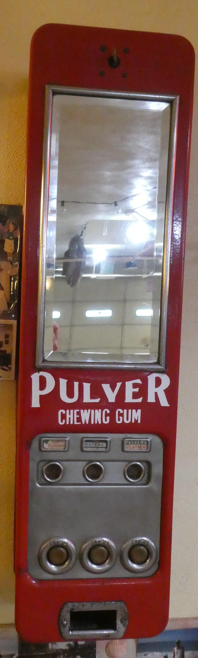 Antique Pulver Chewing Gum Vending Wall Machine: Antique Pulver Chewing Gum 1 cent Vending Wall Machine with beveled glass mirror. Measurements in inches: 8 x 6 1/2 x 31 high Condition:Some touch up chips, bottom left chipped corner Shipping:We offe