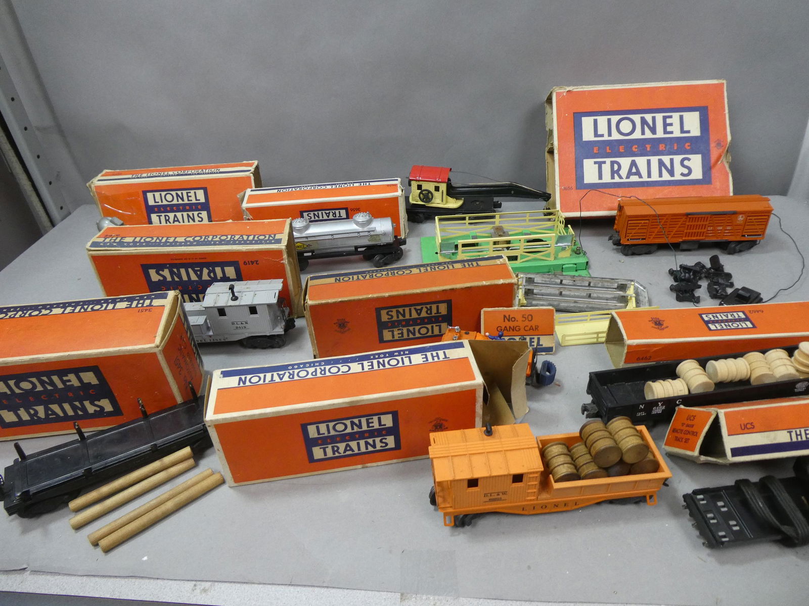 Lot 10 Early Lionel Assorted Train Cars in Boxes: Lot 10 Early Lionel Assorted Train Cars in Boxes including UCS Remote Control Track Set, 3656 Stock Car Outfit, 6462 Gondola, 2419 Wrecking Car, 6119-25 Work Caboose 3451 Auto Lumber Car, 2560 crane (