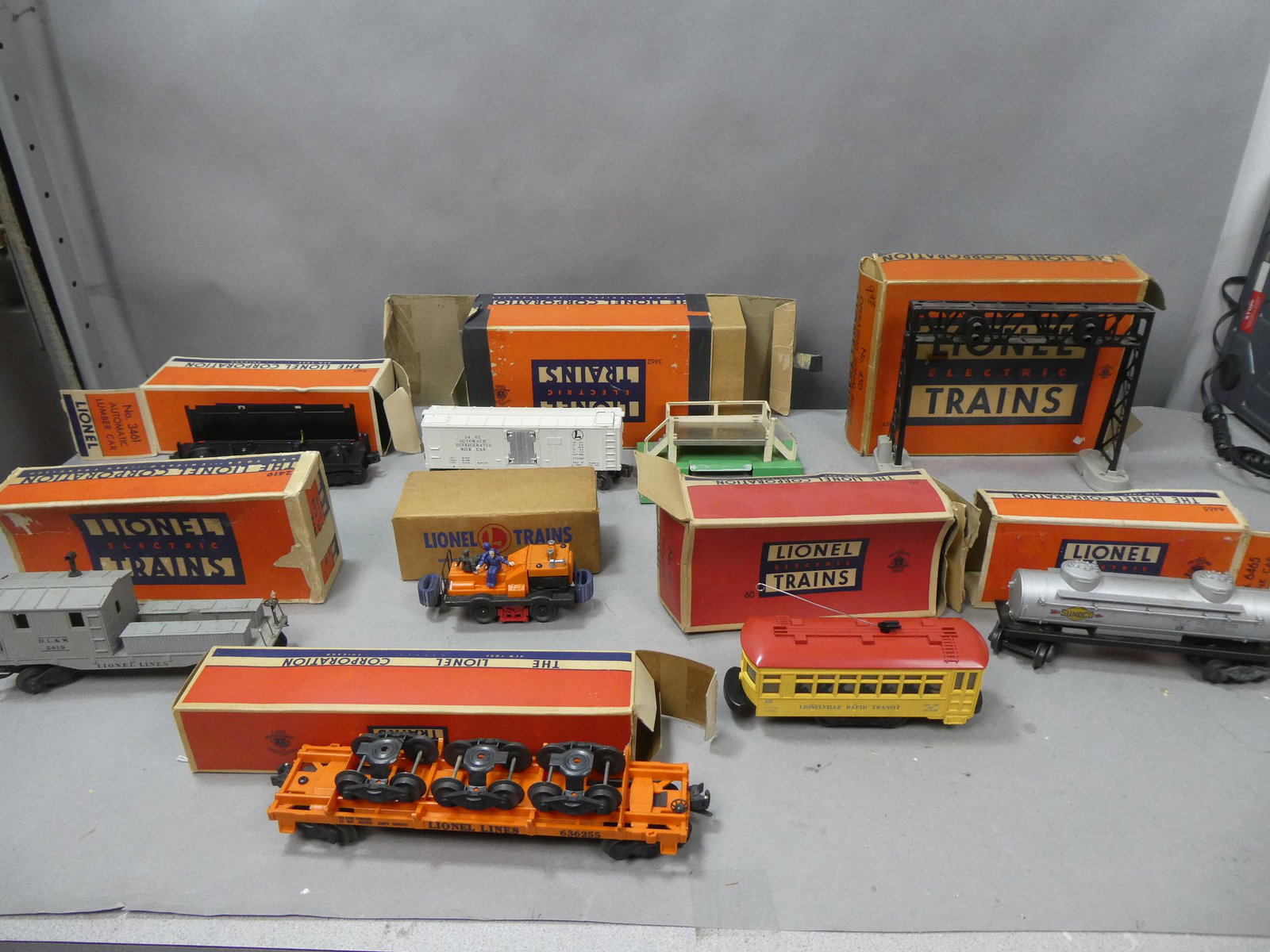 Lot 8 Early Lionel Assorted Train Cars in Boxes: Lot 8 Early Lionel Assorted Train Cars in Boxes including 6465 tank car, 450 Operating Signal Bridge, 3462 Operating Milk Car, 6461 Auto Lumber Car, 60 Trolly, 50 Gang Car, 2419 Wrecking Car and 6362 