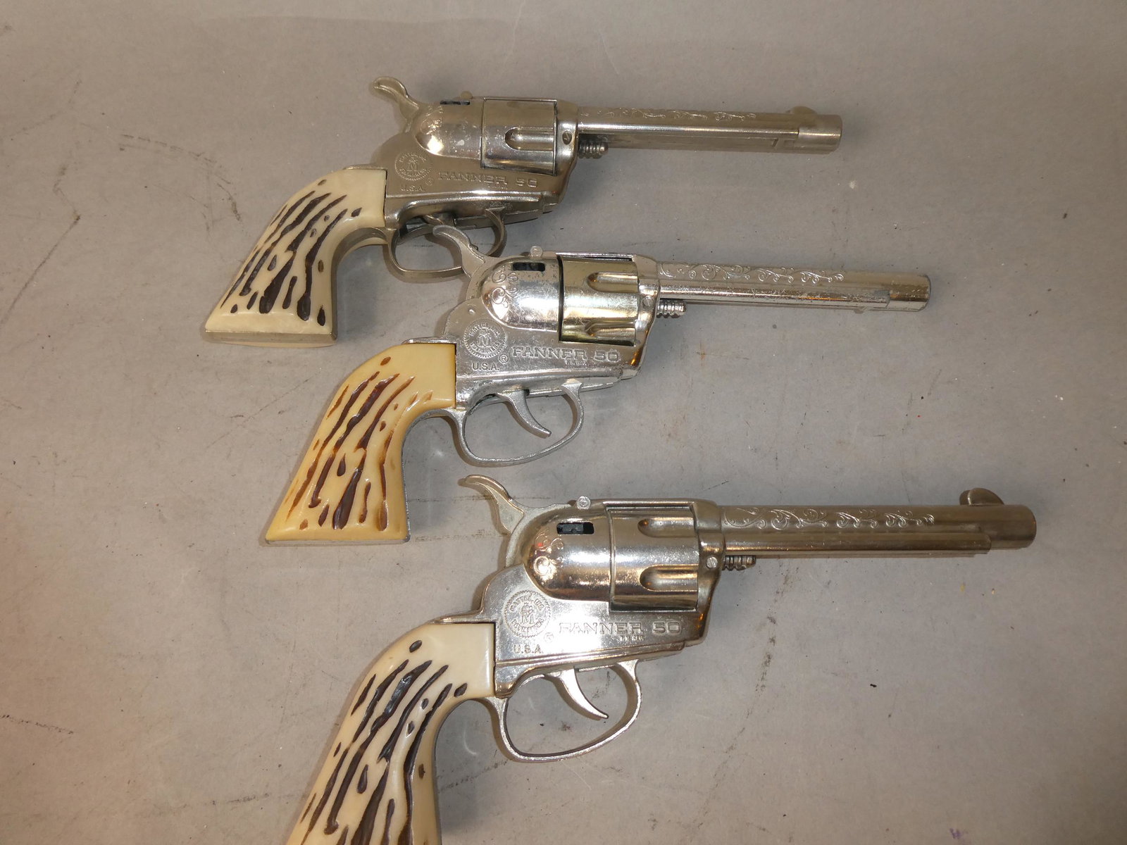 Lot 3 1950's Fanner 50 Cowboy Western Cap Guns: Lot 3 1950's Fanner 50 Cowboy Western Cap Guns. Measurements in inches: 10 3/4 long Condition:All fire, normal wear with age and use Shipping:We offer in-house shipping. Item(s) will be packed after i