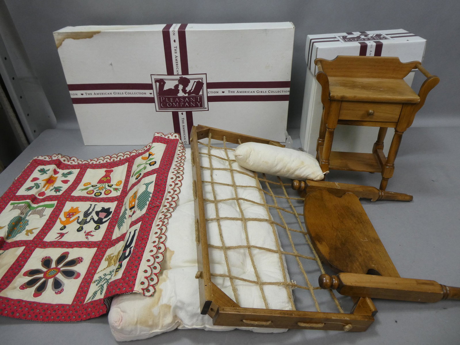 American Girl Addy's Wood Bedroom Rope Bed & Washstand: American Girl Addy's Wood Bedroom Rope Bed & Washstand with mattress, pillow and blanket. With boxes. Measurements in inches: 10 x 8 x 5 washstand Condition:Some stains to box and mattress Shipping:We