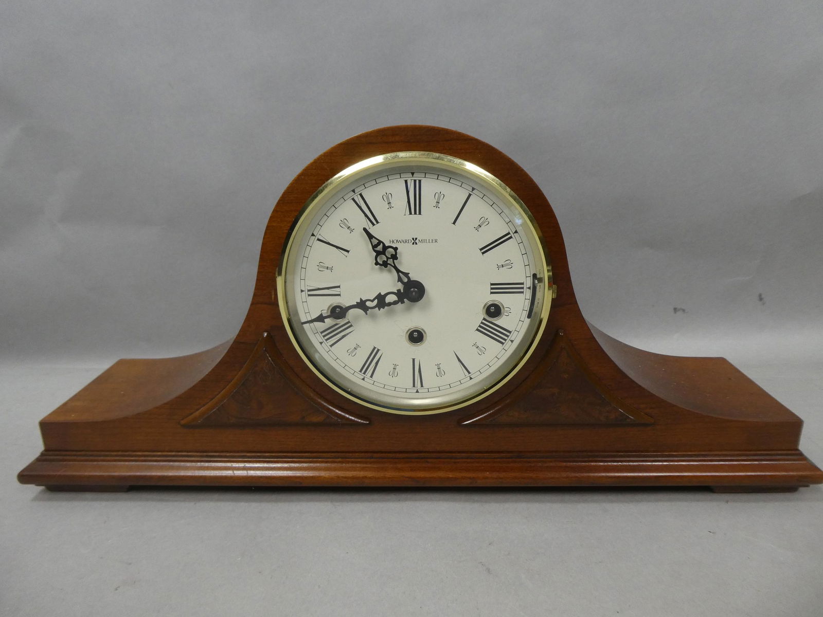 Howard Miller 612-374 Mahogany Wood Humpback Clock: Howard Miller 612-374 Mahogany Wood Humpback Clock with key. Measurements in inches: 9 high x 10 x 5 Condition:Good with no problem and in working condition Shipping:We offer in-house shipping. Item(s