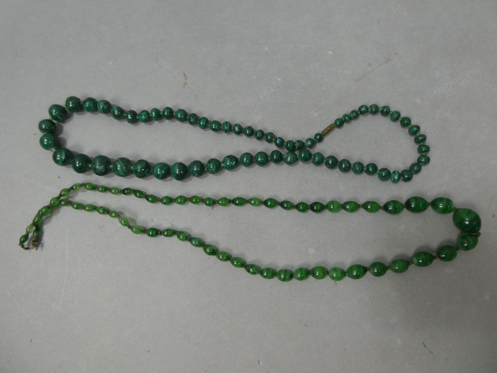 Pair Antique Malachite Green Agate Beaded Necklaces: Pair Antique Malachite Green Agate Beaded Necklaces. Measurements in inches: 22 and 25 long Condition:Normal wear with age and use Shipping:We offer in-house shipping. Item(s) will be packed after inv