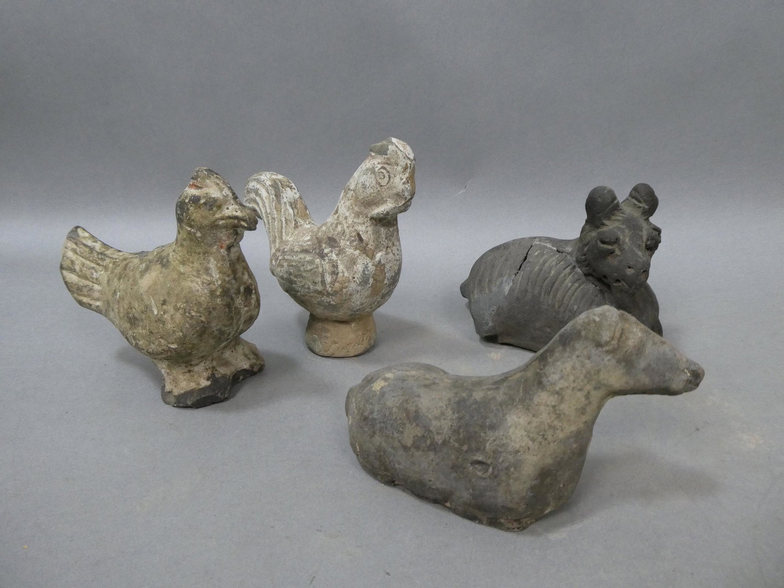 Lot 4 Chinese Han? Dynasty Small Clay Animal Toy Figures: Lot 4 Chinese Han? Dynasty Small Clay Animal Toy Figures including roosters, horse and goat. Measurements in inches: 3, 4 and 5 high Condition:As found, All excavated materials have some restoration. 