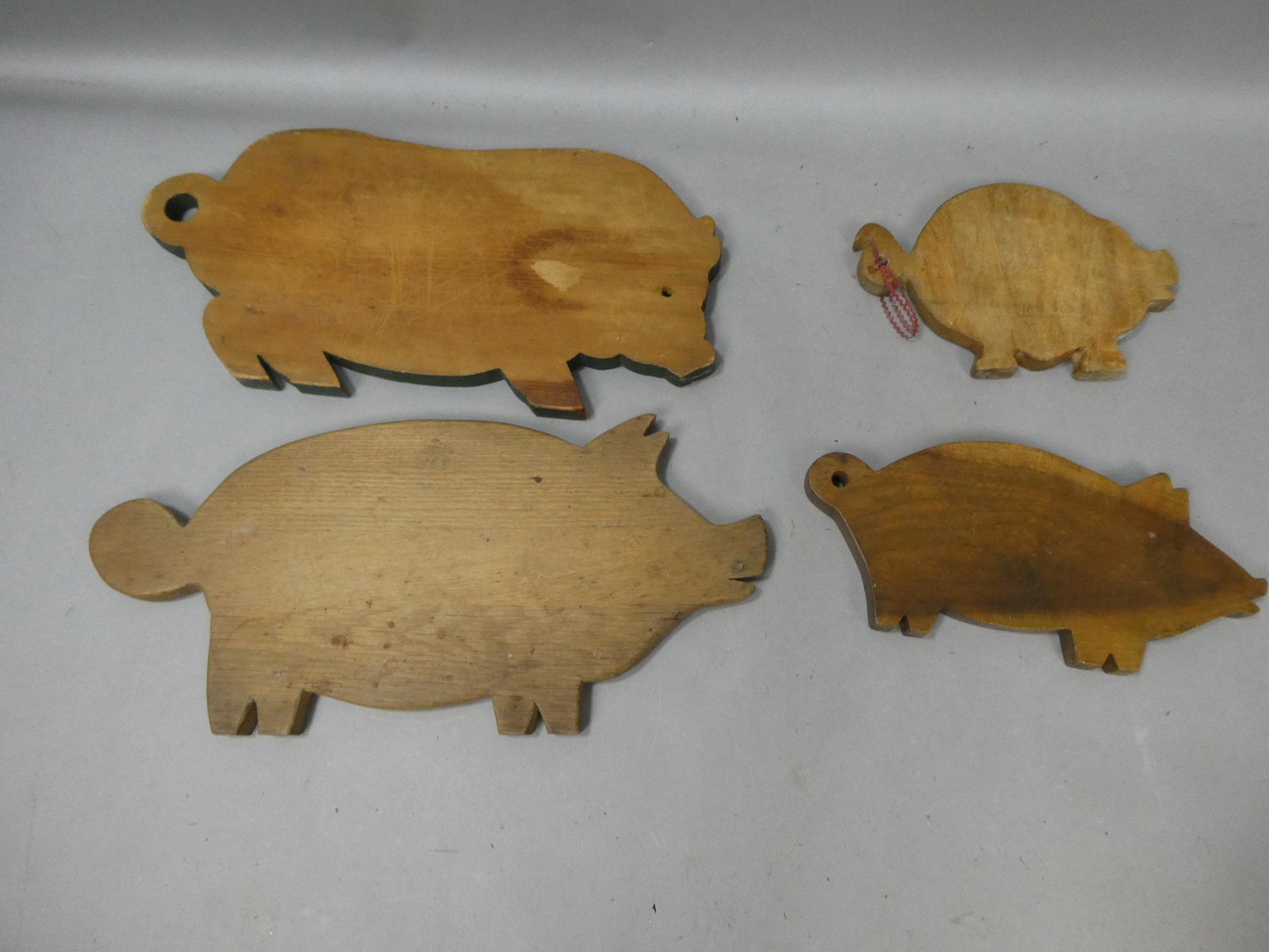 Lot 4 Antique Primitive Wooden Pig Shaped Kitchen Cutting Boards: Lot 4 Antique Primitive Wooden Pig Shaped Kitchen Cutting Boards. Measurements in inches: 9 x 6 to 18 x 9 Condition:Normal wear with age and use Shipping:We offer in-house shipping. Item(s) will be pa