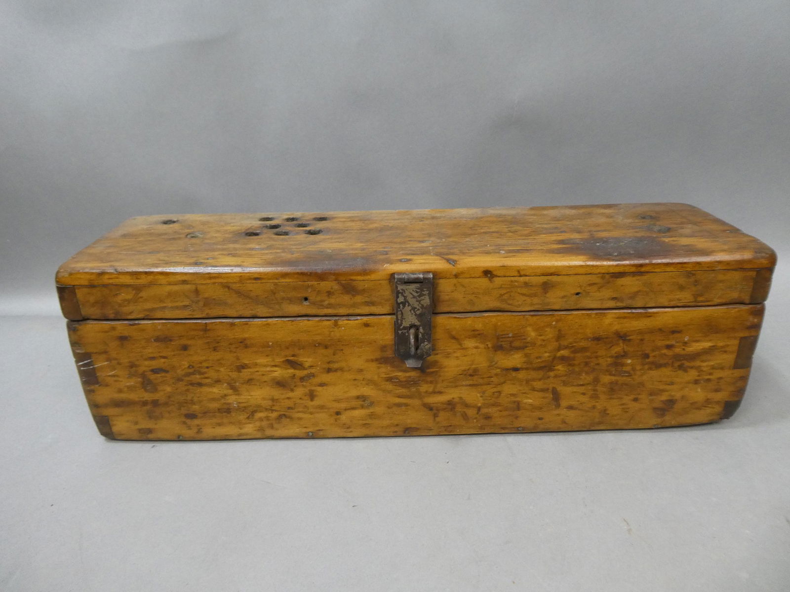 Primitive Antique Wooden Lidded Dovetailed Long Box: Primitive Antique Wooden Lidded Dovetailed Long Box with drilled holes on lid and sides. Measurements in inches: 20 x 6 5 1/2 Condition:Normal wear with age and use Shipping:We offer in-house shipping