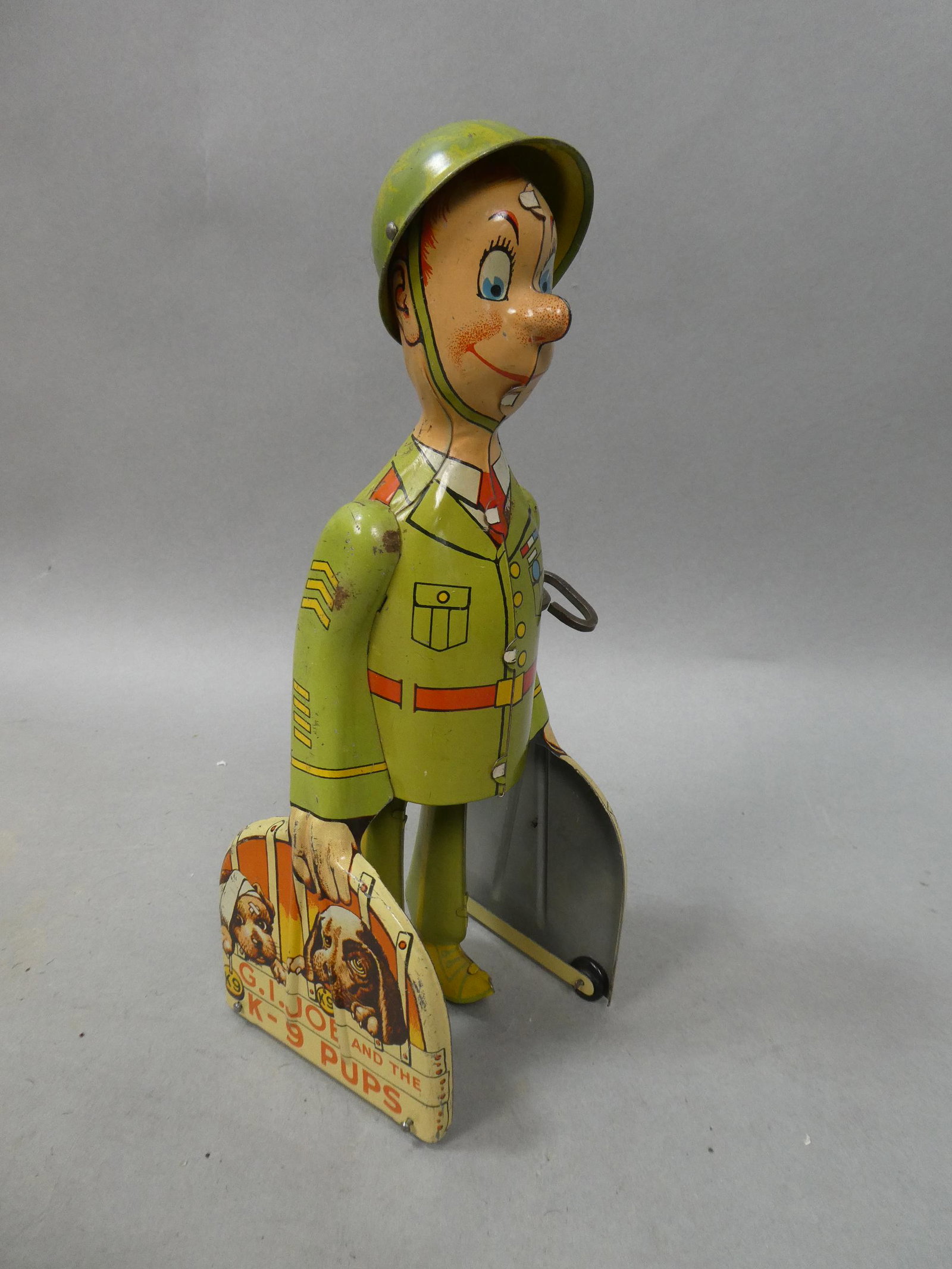 1950's Unique Art GI Joe & The K-9 Pups Tin Wind-up: 1950's Unique Art GI Joe & The K-9 Pups Tin Wind-up. Measurements in inches: 9 high Condition:Winds up and works Shipping:We offer in-house shipping. Item(s) will be packed after invoice is paid and s
