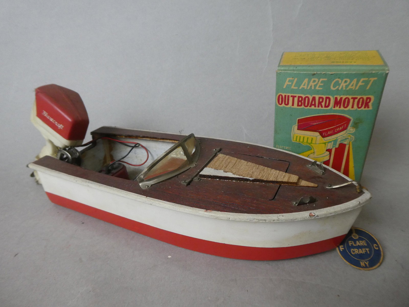1950's Japan Flare Craft Wooden Boat & Outboard Motor: 1950's Japan Flare Craft Wooden Boat & Outboard Motor with original box. Measurements in inches: 10 long Condition:Some damage to top of boat, not tested Shipping:We offer in-house shipping. Item(s) w